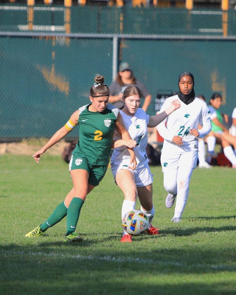 Cougars and Rangers fight over soccer ball control.