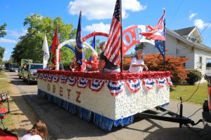Mayor of Obetz, Angela Kirk, throws candy to parade crowd.